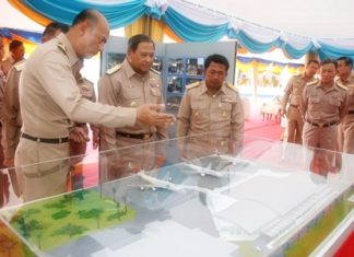 Navy Commander in Chief Adm. Kamthorn Pumhiran (center) and high ranking officers inspect a model of the new facilities at U-Tapao Pattaya International Airport.